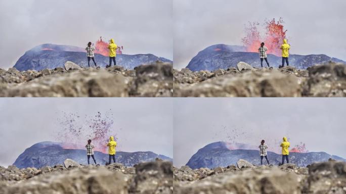 旅行者俯瞰喷发火山景观的壁纸视图