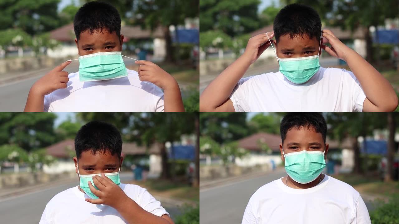 亚洲男孩在自然公园喂鱼并戴口罩防止冠状病毒爆发