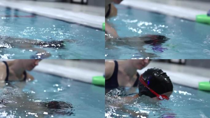 戴着黑水帽的小男孩在游泳课上潜入游泳池