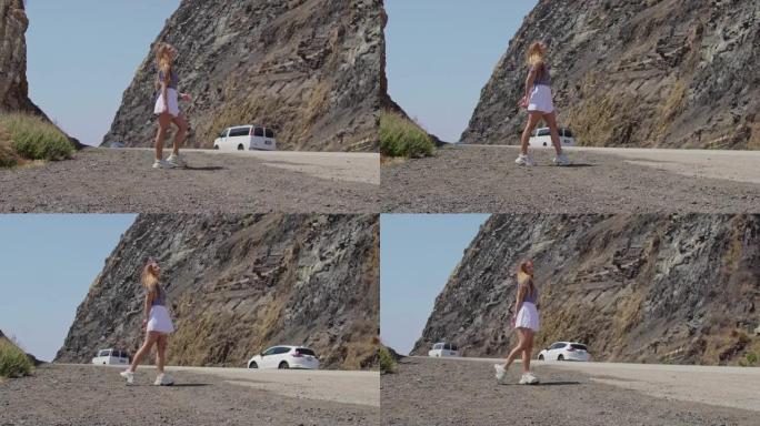 美丽性感快乐的女孩享受假期旅行山背景。穿着白色裙子的年轻漂亮金发女人。