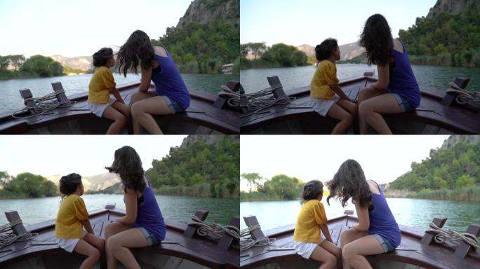 两个快乐的妹妹在日落时乘坐帆船旅行的4k视频片段