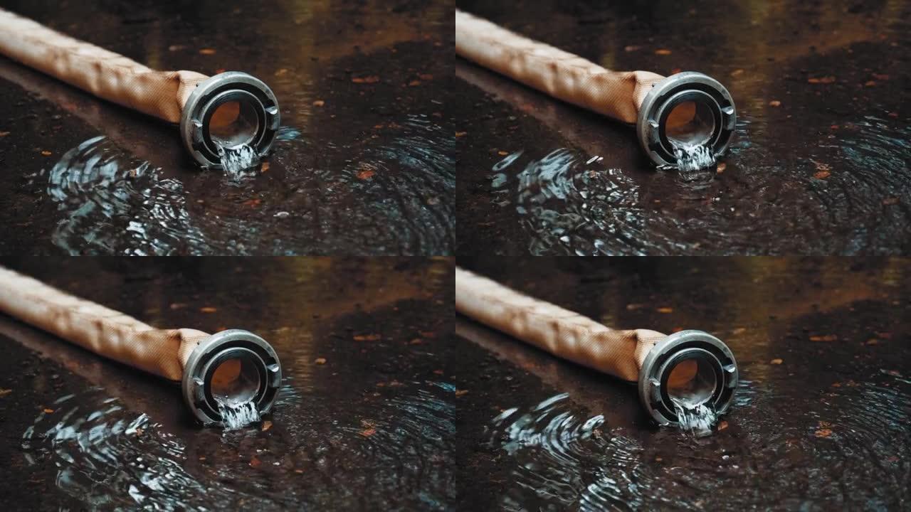 用金属铝耦合器从聚酯消防水带流出的清水