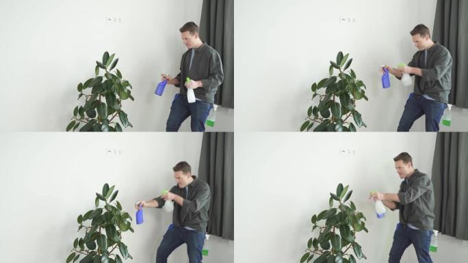 男人在家用喷雾瓶在室内植物花上喷水。家务和家庭概念