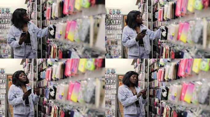 黑人妇女，在商店里测量手机盖，看它是否适合她的手机