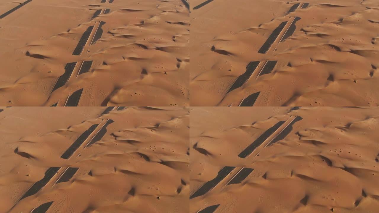 沙丘掩埋的沙漠路鸟瞰图。阿联酋迪拜。