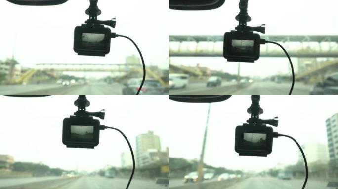 挂在汽车挡风玻璃上的行车记录仪的特写镜头记录了白天在4k中穿越高速公路的行程路线