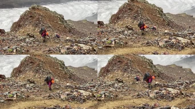 一位疲倦的游客沿着一条山路跌跌撞撞地走过石头和巨石。