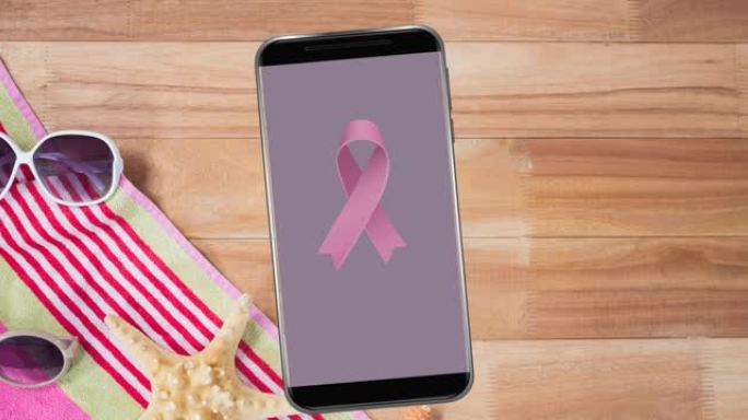 智能手机屏幕上粉色乳腺癌丝带标志的动画
