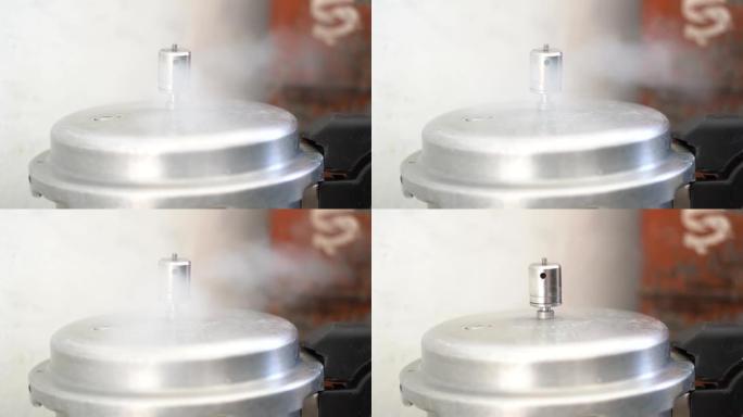 从厨房的高压锅中释放蒸汽的慢动作镜头。