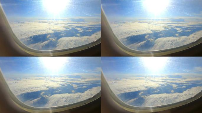 太阳和云彩穿过飞机的窗户