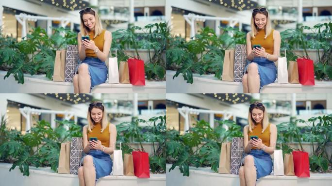 购物中心的年轻女性消费者浏览聊天并使用智能手机
