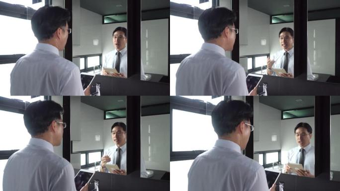 4k亚洲商人在镜子前练习演讲