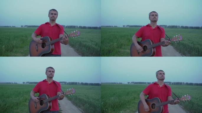 男子走在田野的土路中心，用原声吉他演奏