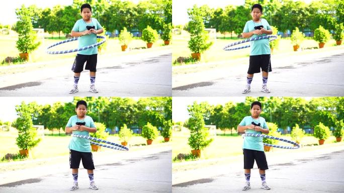 亚洲男孩玩呼啦圈，学校假期在学校锻炼，停止新型冠状病毒肺炎