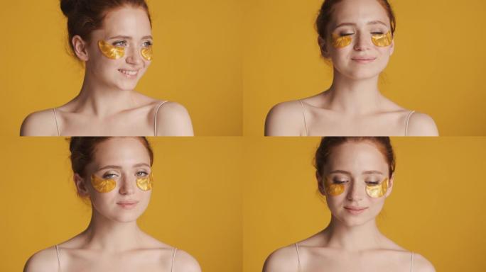 金色眼罩中的迷人女孩的肖像在彩色背景上摆在相机上