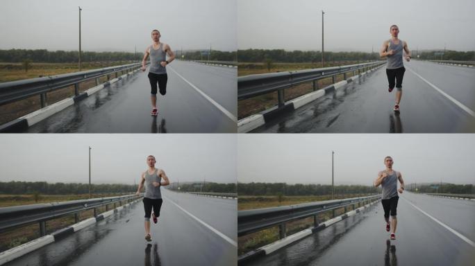 雷暴期间，运动员快速沿高速公路奔跑，正视图。运动男子在雨中在路上跑马拉松。短跑运动员做锻炼