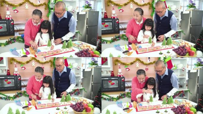孙子，十几岁的女孩与祖父母，祖父，祖母一起学习准备圣诞树蛋糕。东南亚多代家庭的概念，在厨房里有一个孩