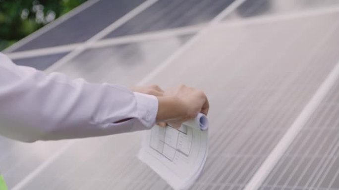 工程师在太阳能电池面板总结报告上打开太阳能农场项目蓝图