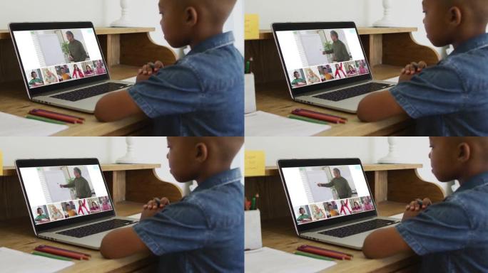 非裔美国男孩拿着铅笔在家里的笔记本电脑上进行视频会议