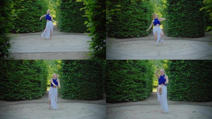 迷人的年轻女子穿着白色连衣裙庆祝。赤脚慢动作跳舞。幸福的女人在公园享受自由和生活。