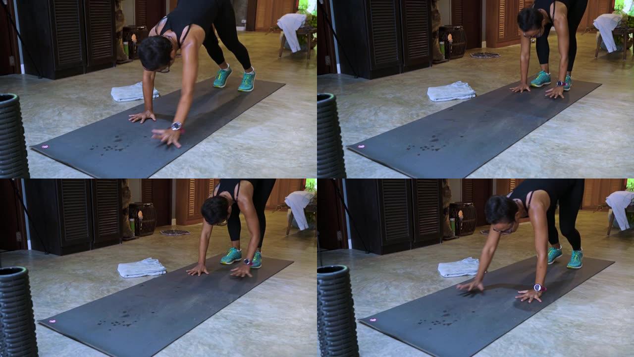 成熟的爱莎女人进入瑜伽木板位置健身程序