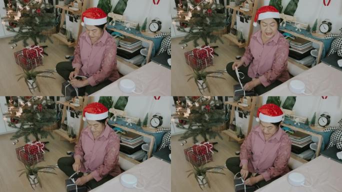 泰国高级女性喜欢在儿童卧室为孙子制作圣诞礼品盒时与人工智能扬声器朋友交谈 -- 股票视频