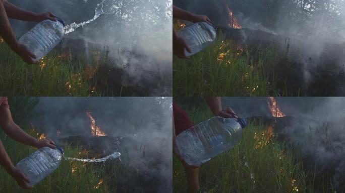 一个志愿的男人或男孩扑灭一场野火。用塑料瓶倒水。雨林野火灾害，干燥灌木丛燃烧，火灾原因。