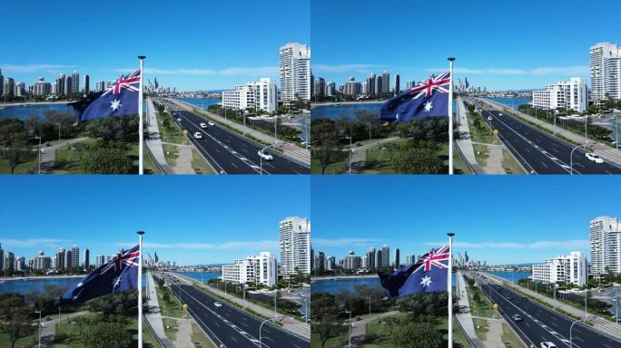 在繁忙的道路网络旁，通向高耸的城市天际线，在微风中挥舞着澳大利亚国旗的特写镜头。