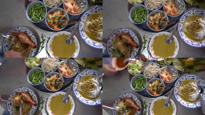 吃卡诺姆·吉恩、米饭粉丝面条配咖喱和蔬菜以及炸鸡泰国普吉岛当地传统餐