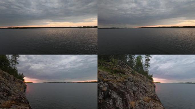 湖岸上红日的美妙日落。湖岸多岩石，景色很美。