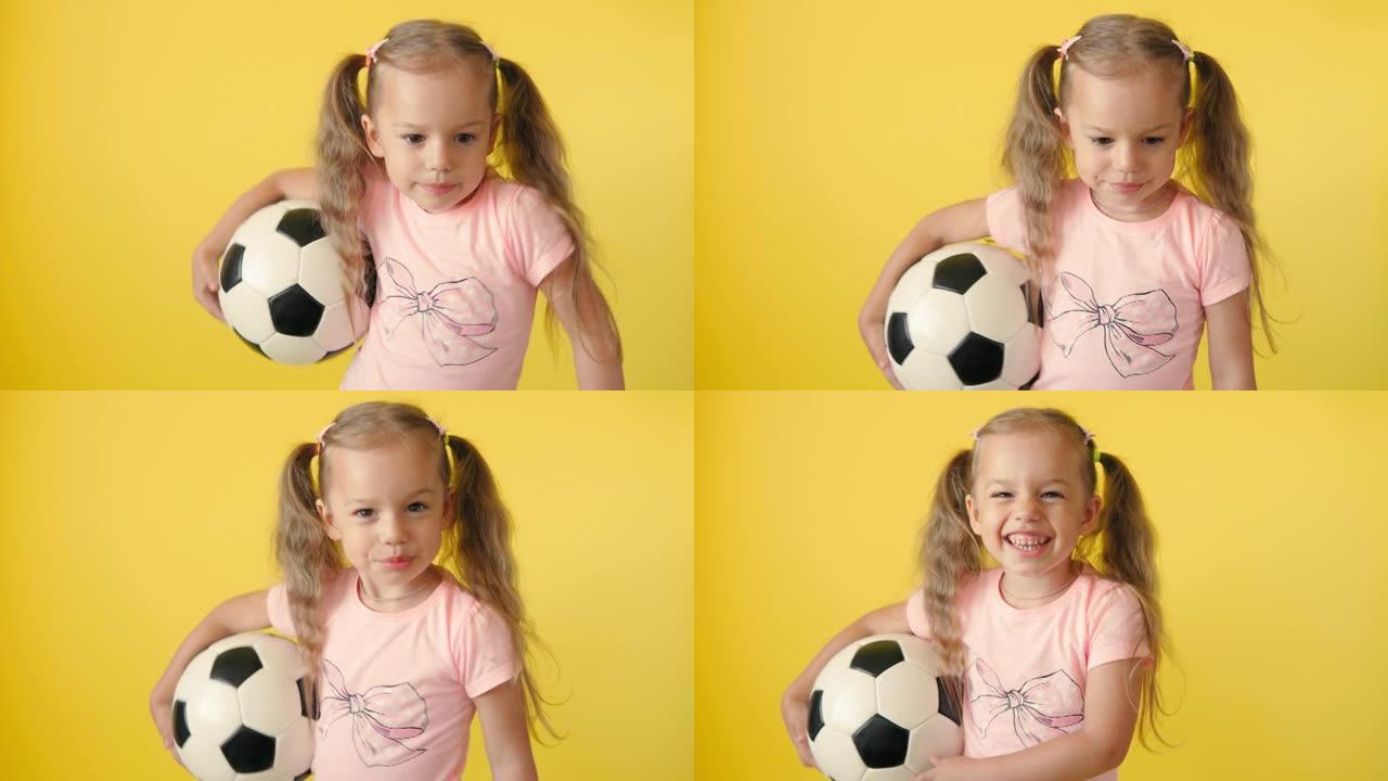 正宗可爱的微笑学龄前小女孩与经典的黑白足球看相机在黄色背景。儿童穿着t恤和短裤踢足球。运动，冠军，团