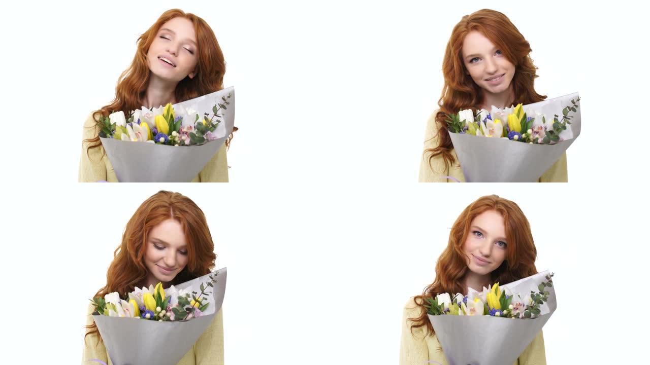 长卷发红头发的幸福女人闻到白色背景上的花朵