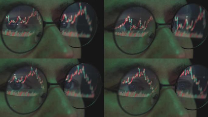 股市交易员看着股价图，眼镜男经纪人分析率，近景。