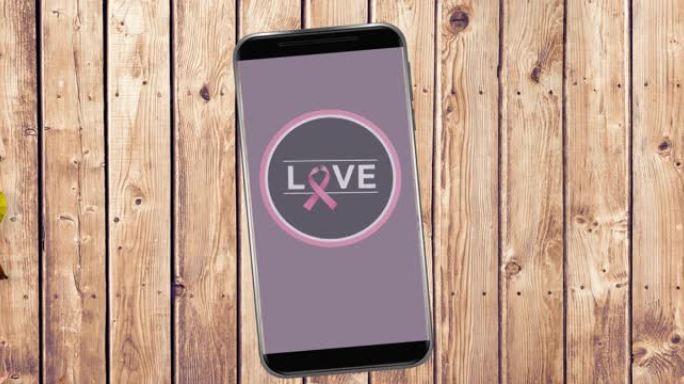 动画粉红乳腺癌丝带标志与爱的文字在智能手机屏幕