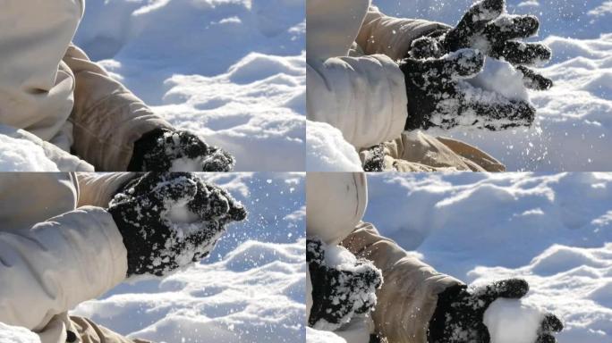 少年男孩在冬天玩雪，做雪球，并在手中扔雪。美丽阳光明媚的冬日