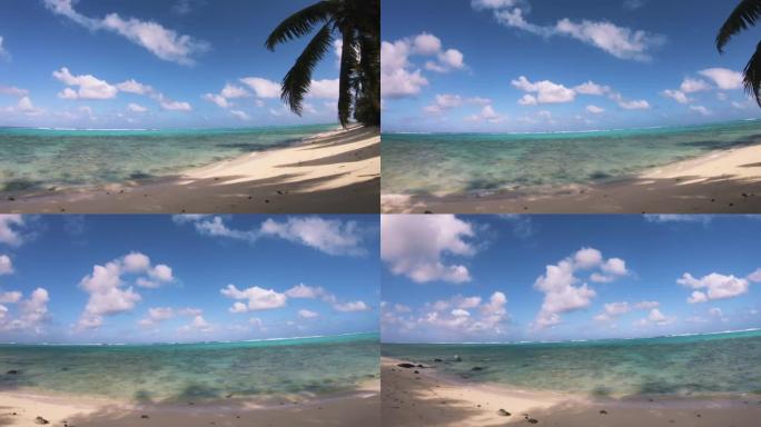 海滩上绿松石色泻湖的宽水平面板视图在阳光明媚的日子里仰望大海，蓝天上有椰子树和一根挂在南太平洋岛屿上