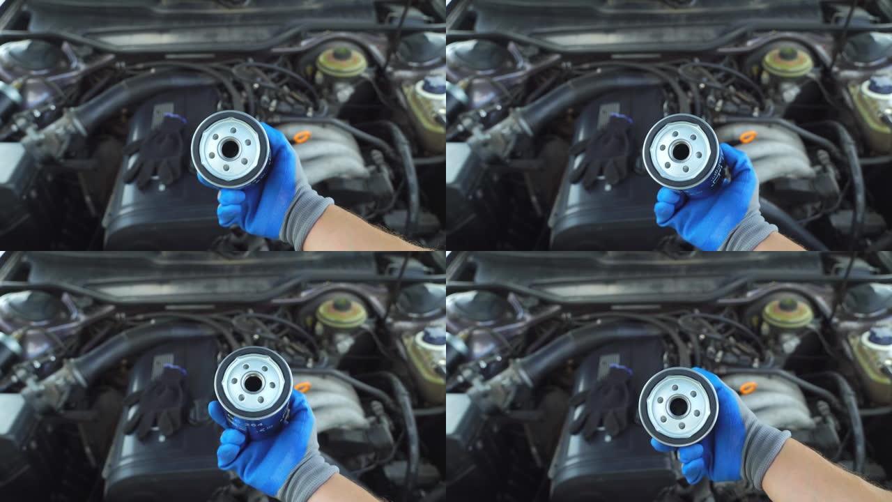 机油滤清器更换汽车发动机维修机械师手握手套特写