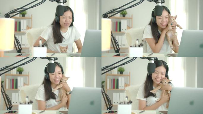 亚洲女学生或女商人在家用电脑和小猫远程工作。新型冠状病毒肺炎流行情况下独自在家工作的社会距离概念。