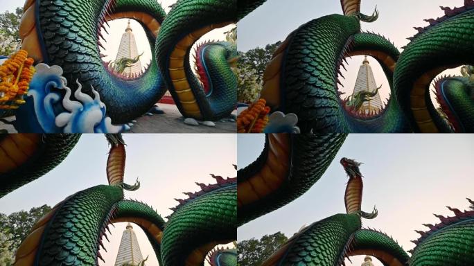 彩虹雕刻蛇或五颜六色的泰国纳迦围绕着斯里玛哈·波·奇迪佛塔在帕那那农布瓦寺的日落