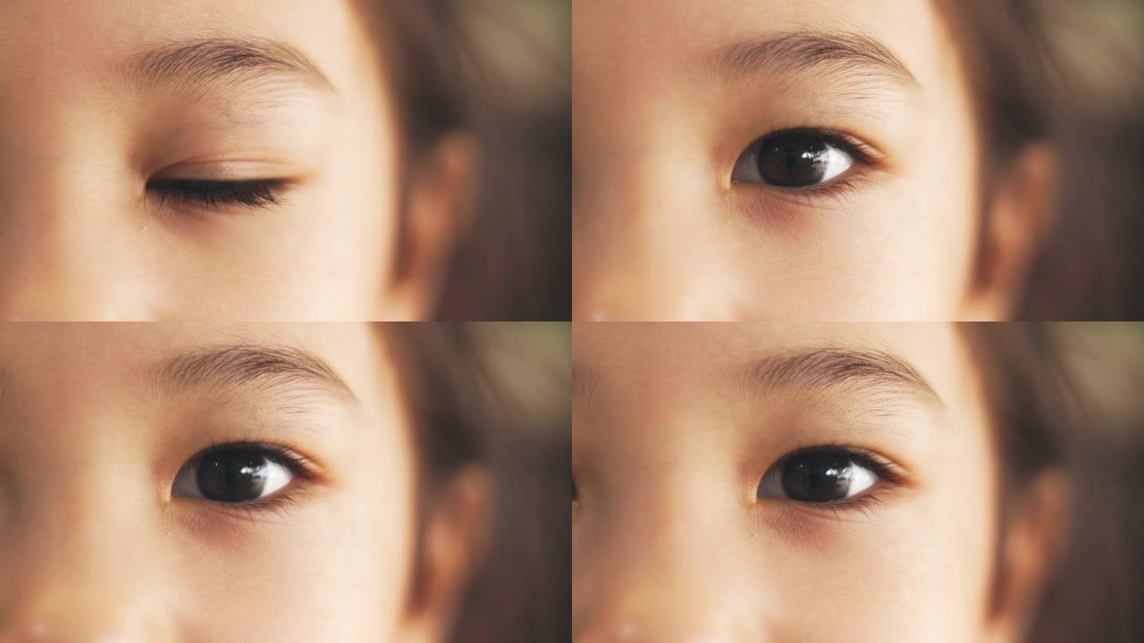 特写4k美丽的眼睛和可爱的亚洲女孩的眉毛，孩子正在寻找相机。它显示出文化多样性的迷人面部表情，并对新
