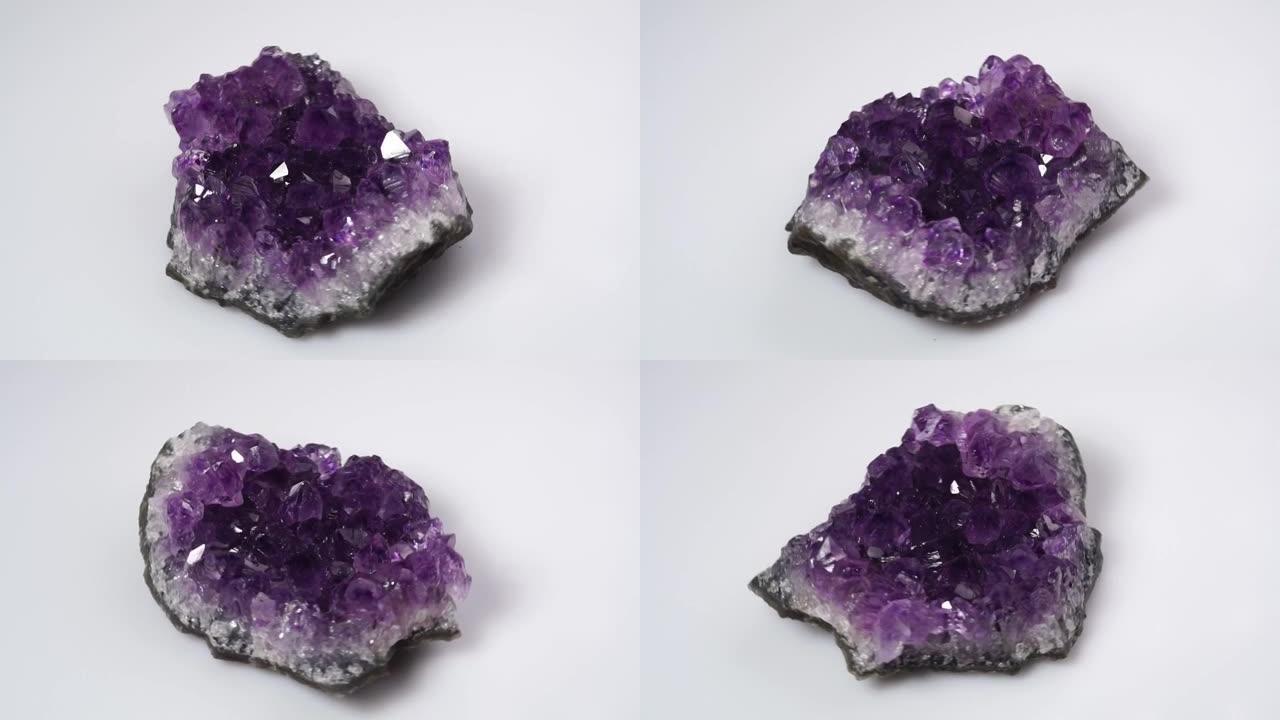 白色背景上的天然紫水晶druzy旋转