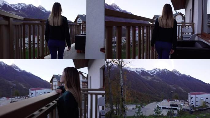 一个女孩沿着山里一所房子的阳台走，走到栏杆上，向山望去。美丽的风景