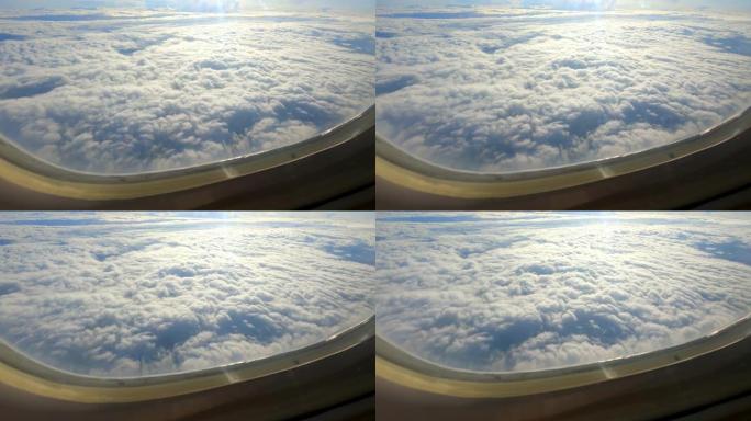 无尽的云层穿过飞机的窗户