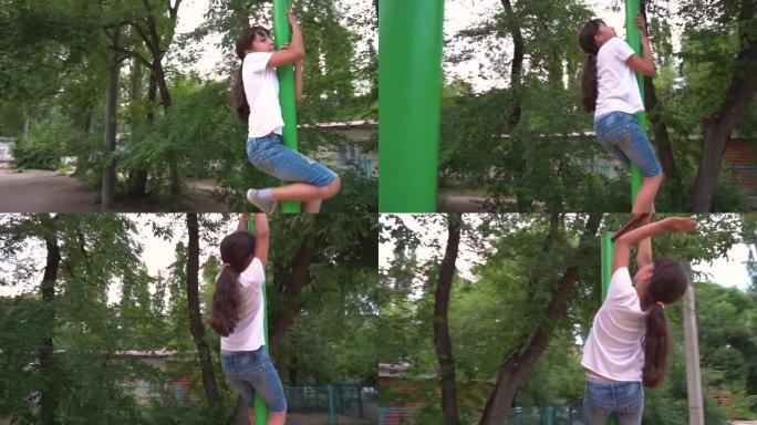 一个女孩爬上绿色的单杠