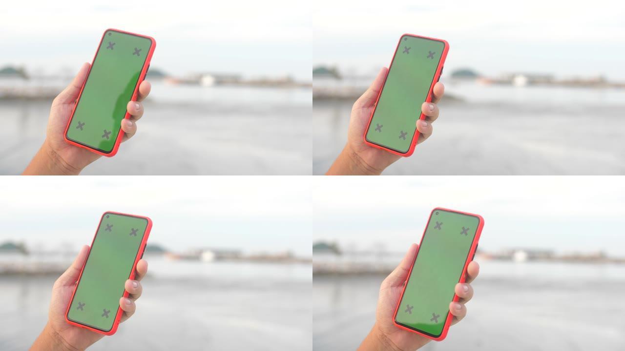 色度键、智能手机、背景为海洋的绿屏智能手机