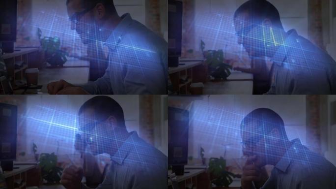 在办公室使用计算机对白人男子进行发光的蓝色心率监测器