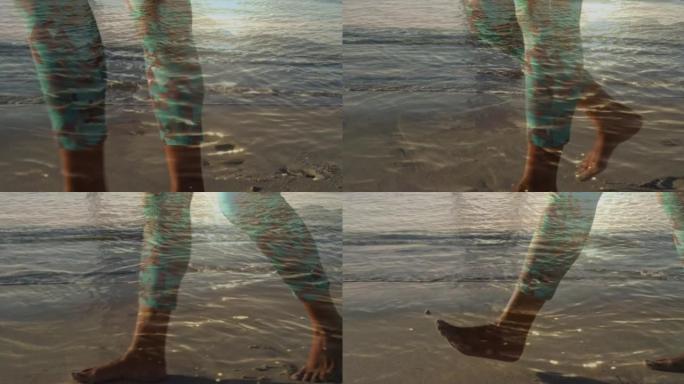 男人的腿在沙滩上行走，在海上晒太阳的动画