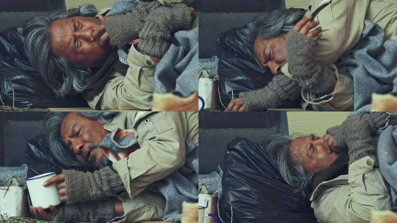 4k高级无家可归者睡在城市的人行道上。