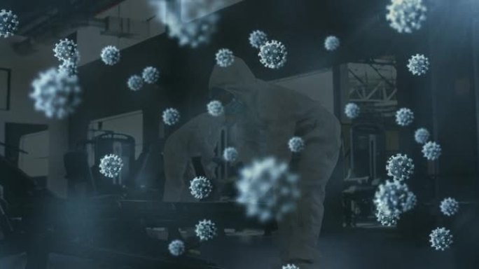 多个新型冠状病毒肺炎细胞漂浮在一群使用消毒剂清洁健身房的卫生工作者上