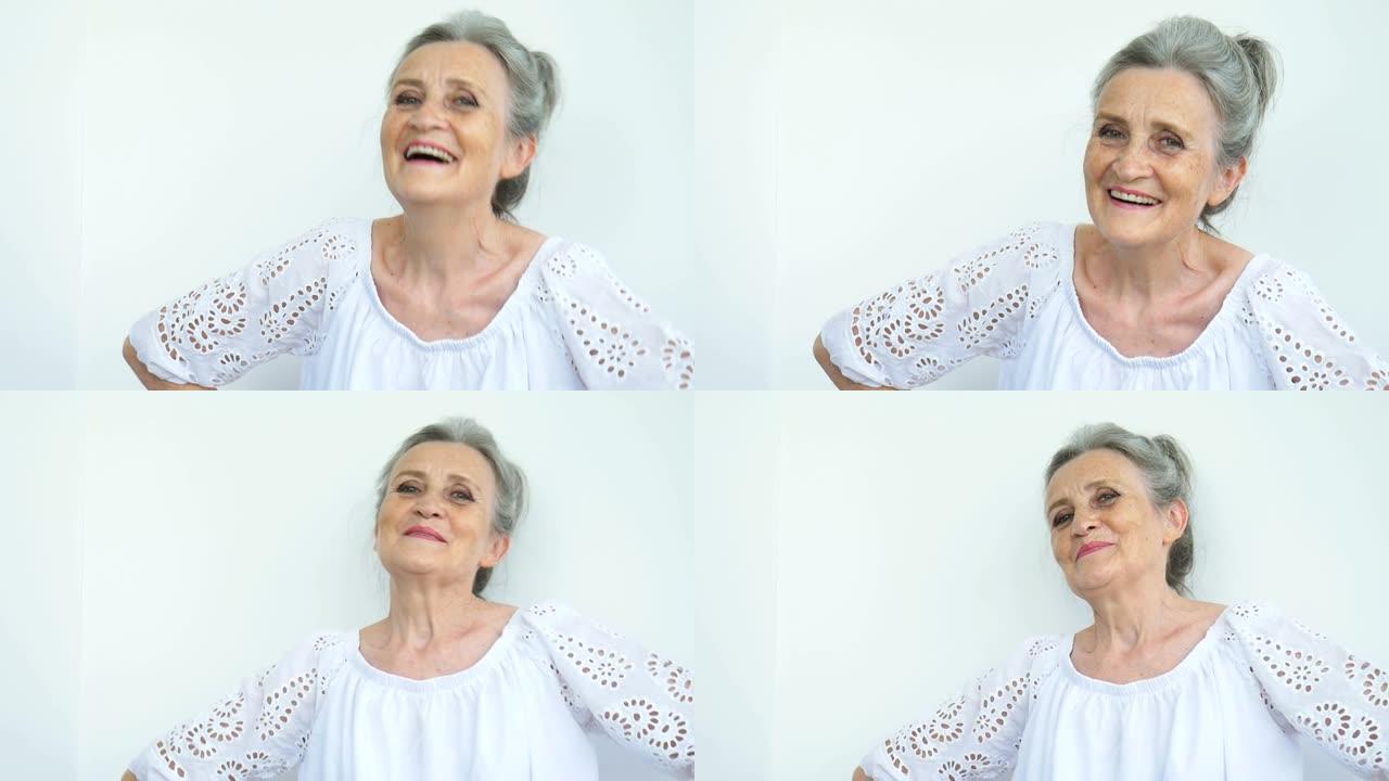 美丽的老奶奶，白发苍苍，满脸皱纹，在白色背景上微笑着看着镜头，母亲节，退休快乐